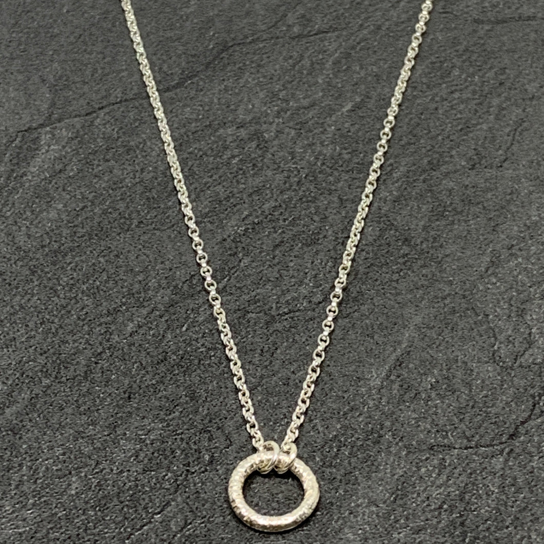 Hammered silver open circle pendant